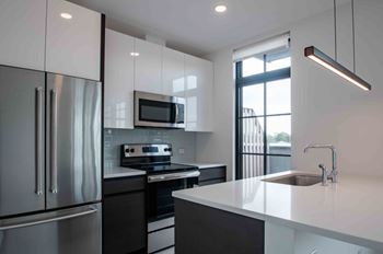 Gray slate tiled kitchen floors with polished white, glass subway tile backsplash